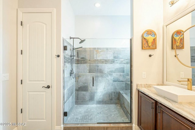 bathroom featuring a shower stall and vanity