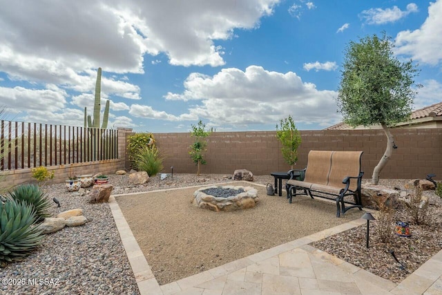 view of patio featuring a fenced backyard and a fire pit