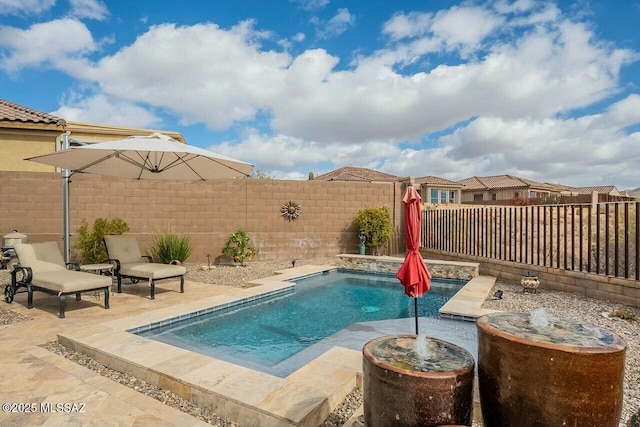 view of pool featuring a patio area and a fenced backyard