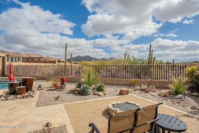 view of patio / terrace featuring a fenced backyard and a mountain view