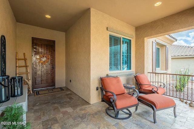 doorway to property featuring stucco siding