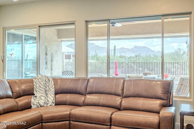 living room featuring a mountain view and a wealth of natural light