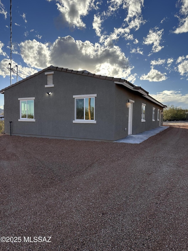 view of property exterior featuring stucco siding and a patio