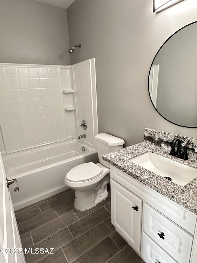 bathroom featuring wood tiled floor, shower / bath combination, vanity, and toilet