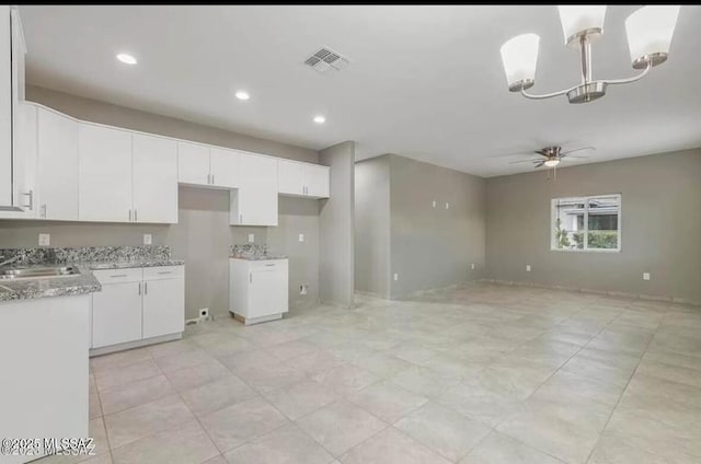 kitchen with recessed lighting, visible vents, a ceiling fan, white cabinetry, and a sink