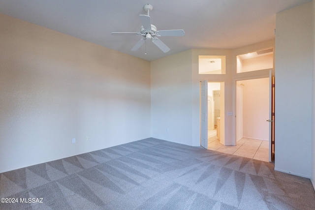 unfurnished room featuring carpet, visible vents, and ceiling fan