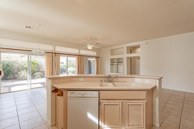 kitchen featuring visible vents, a center island with sink, light countertops, white dishwasher, and a sink