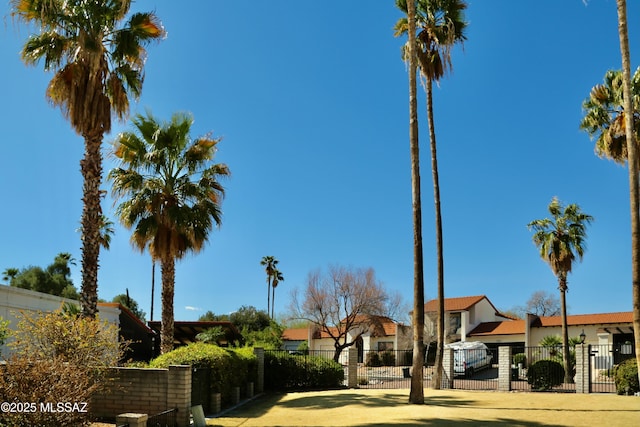 exterior space with a fenced front yard and a gate