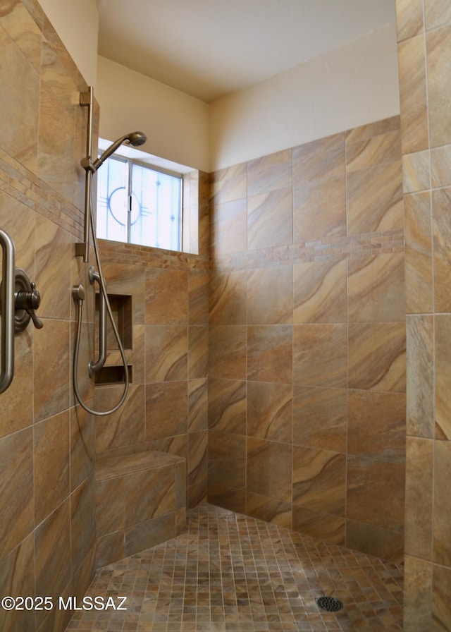 bathroom with tiled shower