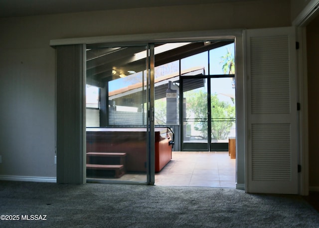 interior space featuring baseboards, carpet flooring, and tile patterned flooring