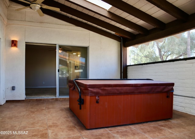 view of patio with a ceiling fan and a hot tub