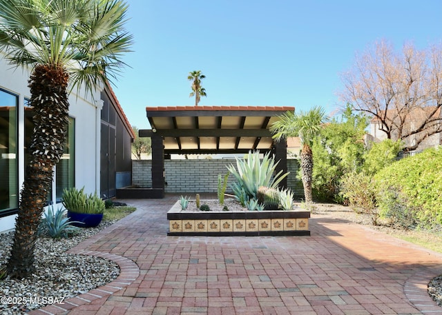 view of patio / terrace with a lanai and fence