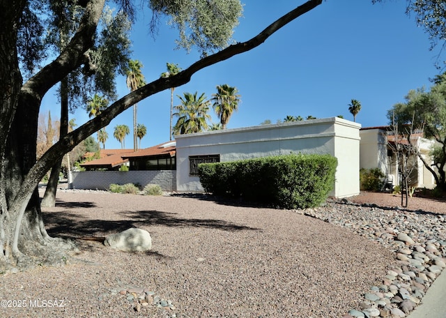 view of side of home featuring stucco siding