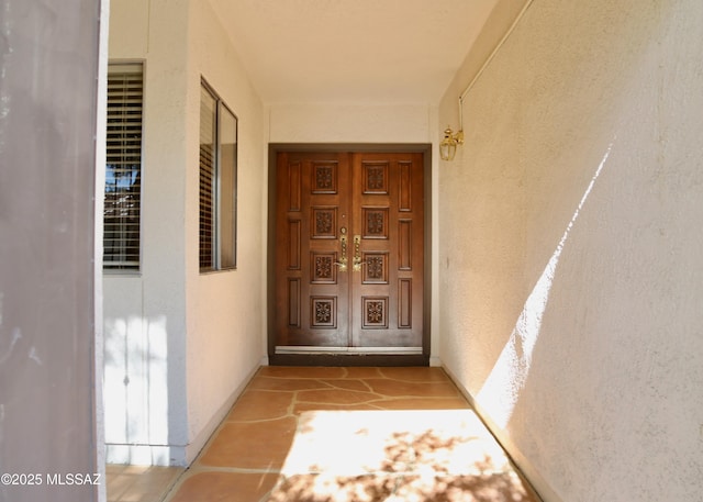 property entrance with stucco siding