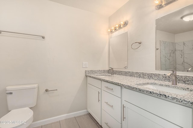 4510 E 6th St, Tucson, AZ 85711 - bathroom with double vanity, toilet, a shower, and baseboards