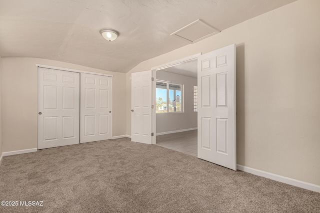4510 E 6th St, Tucson, AZ 85711 - unfurnished bedroom featuring lofted ceiling, attic access, carpet, a closet, and baseboards