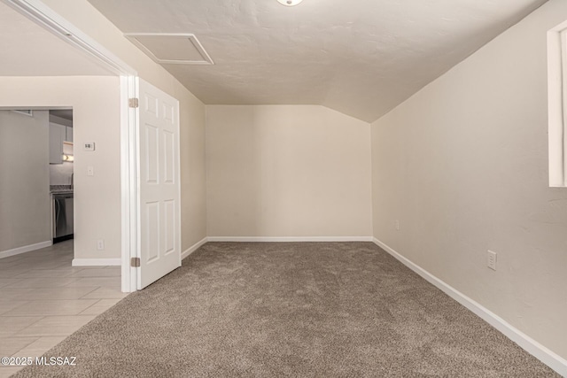 4510 E 6th St, Tucson, AZ 85711 - additional living space with vaulted ceiling, carpet flooring, attic access, and baseboards