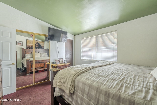 bedroom featuring a closet and dark carpet