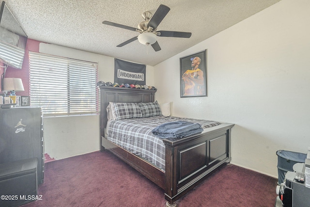 bedroom with a ceiling fan, carpet, and a textured ceiling