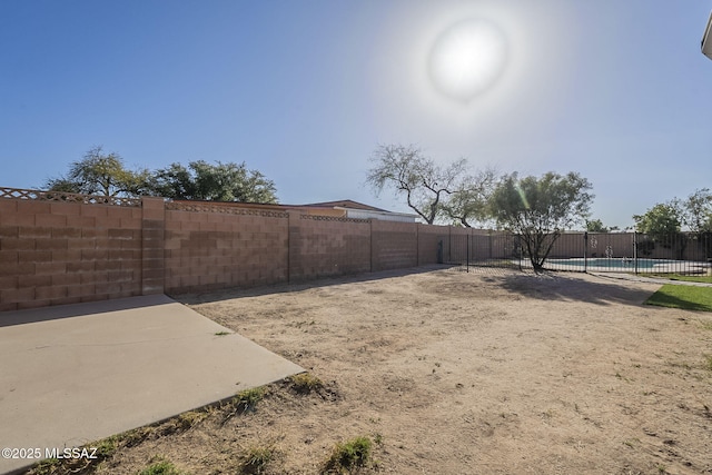 view of yard featuring a fenced in pool and fence