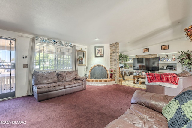 carpeted living area featuring a large fireplace and vaulted ceiling