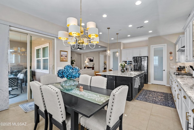 dining area with light tile patterned floors, recessed lighting, visible vents, and an inviting chandelier