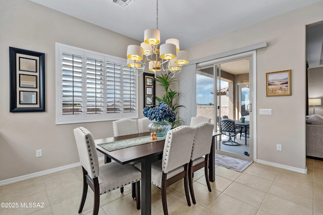 tiled dining area with visible vents, baseboards, and a notable chandelier