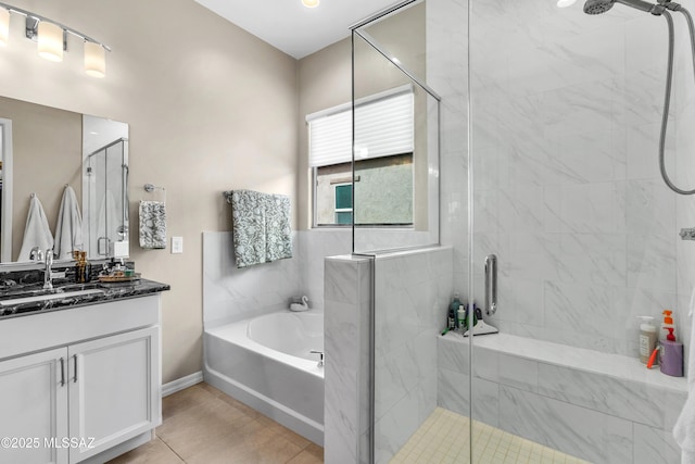 full bath featuring a stall shower, vanity, a bath, and baseboards