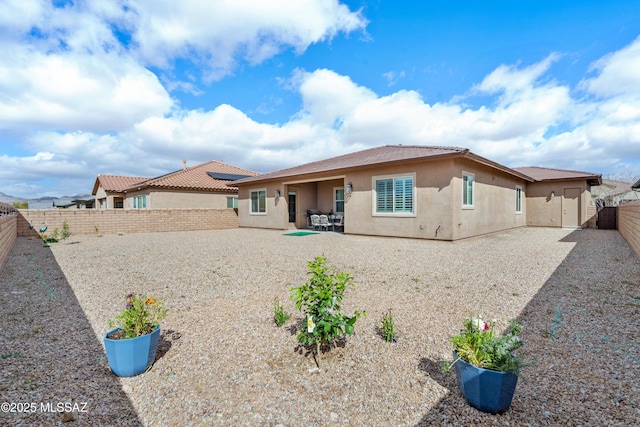 rear view of property with a patio area, a fenced backyard, and stucco siding