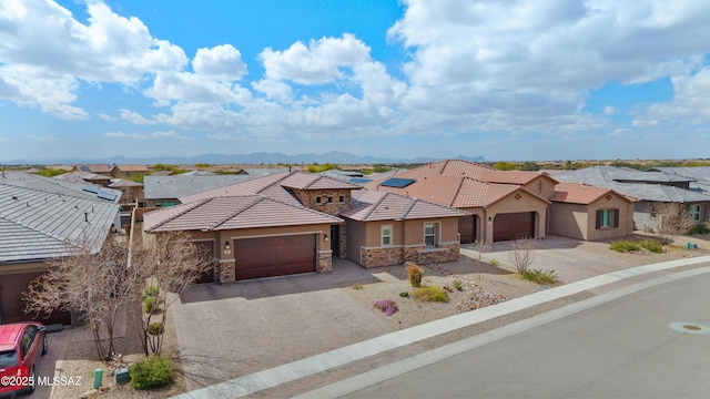 view of front facade with a garage, a residential view, and stone siding