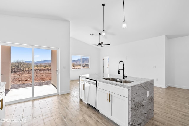 kitchen featuring white cabinets, dishwasher, light wood-type flooring, pendant lighting, and a sink