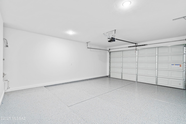 garage with a garage door opener and baseboards