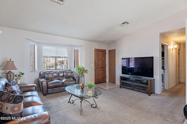 carpeted living area featuring visible vents, vaulted ceiling, and a textured ceiling