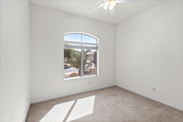 empty room with carpet, baseboards, and ceiling fan