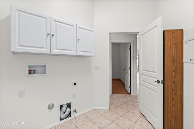 laundry area with light tile patterned flooring, cabinet space, electric dryer hookup, washer hookup, and hookup for a gas dryer