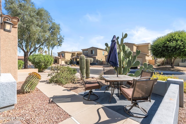 view of patio featuring a residential view and outdoor dining space