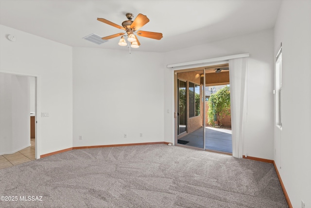 unfurnished room with visible vents, carpet floors, baseboards, and ceiling fan