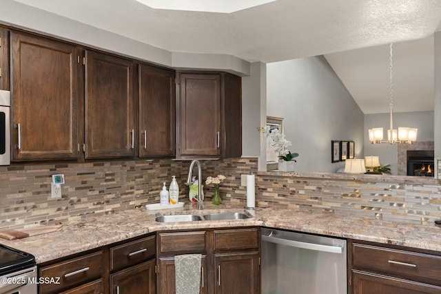 kitchen featuring decorative backsplash, dark brown cabinets, appliances with stainless steel finishes, and a sink