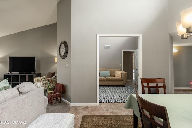 living area featuring carpet flooring, baseboards, visible vents, and high vaulted ceiling