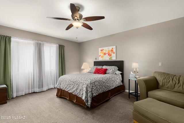 carpeted bedroom with baseboards and a ceiling fan