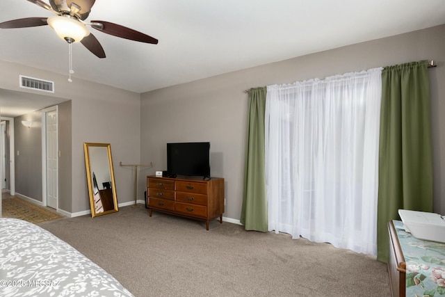 bedroom featuring visible vents, baseboards, and carpet