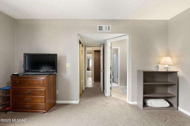 carpeted bedroom featuring visible vents and baseboards