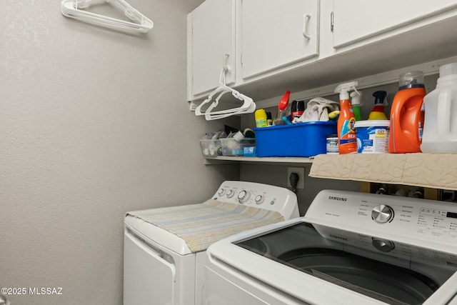 washroom featuring cabinet space and separate washer and dryer