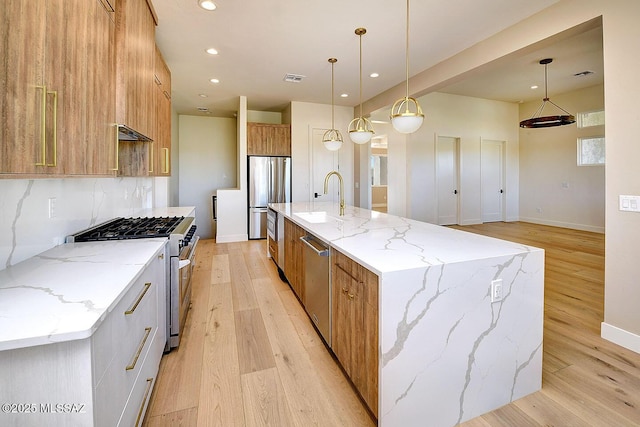 kitchen with brown cabinets, modern cabinets, stainless steel appliances, and a sink