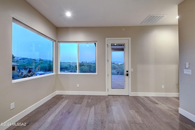 interior space with recessed lighting, visible vents, baseboards, and wood finished floors