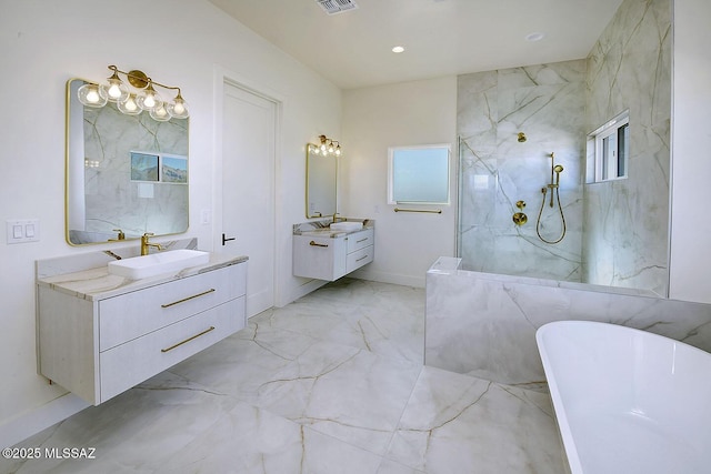 bathroom with a marble finish shower, a sink, marble finish floor, a freestanding bath, and two vanities