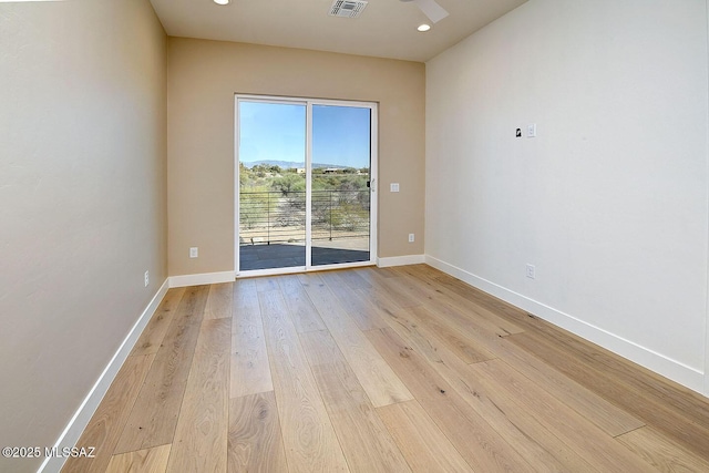 empty room with light wood finished floors, recessed lighting, visible vents, and baseboards