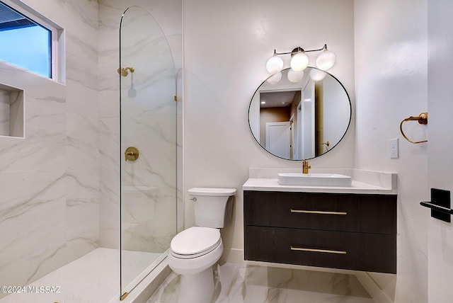 bathroom with toilet, marble finish floor, a marble finish shower, and vanity