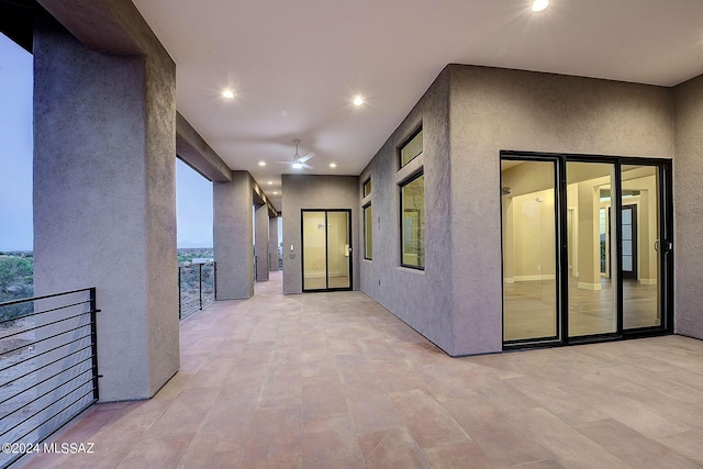 view of patio featuring ceiling fan and a balcony