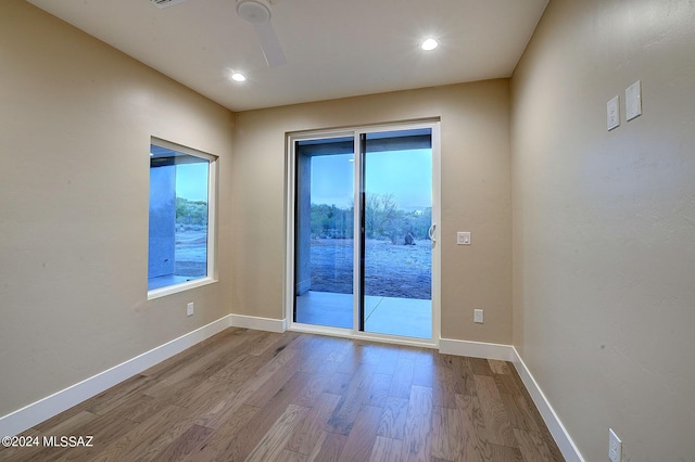 unfurnished room with ceiling fan, baseboards, wood finished floors, and recessed lighting